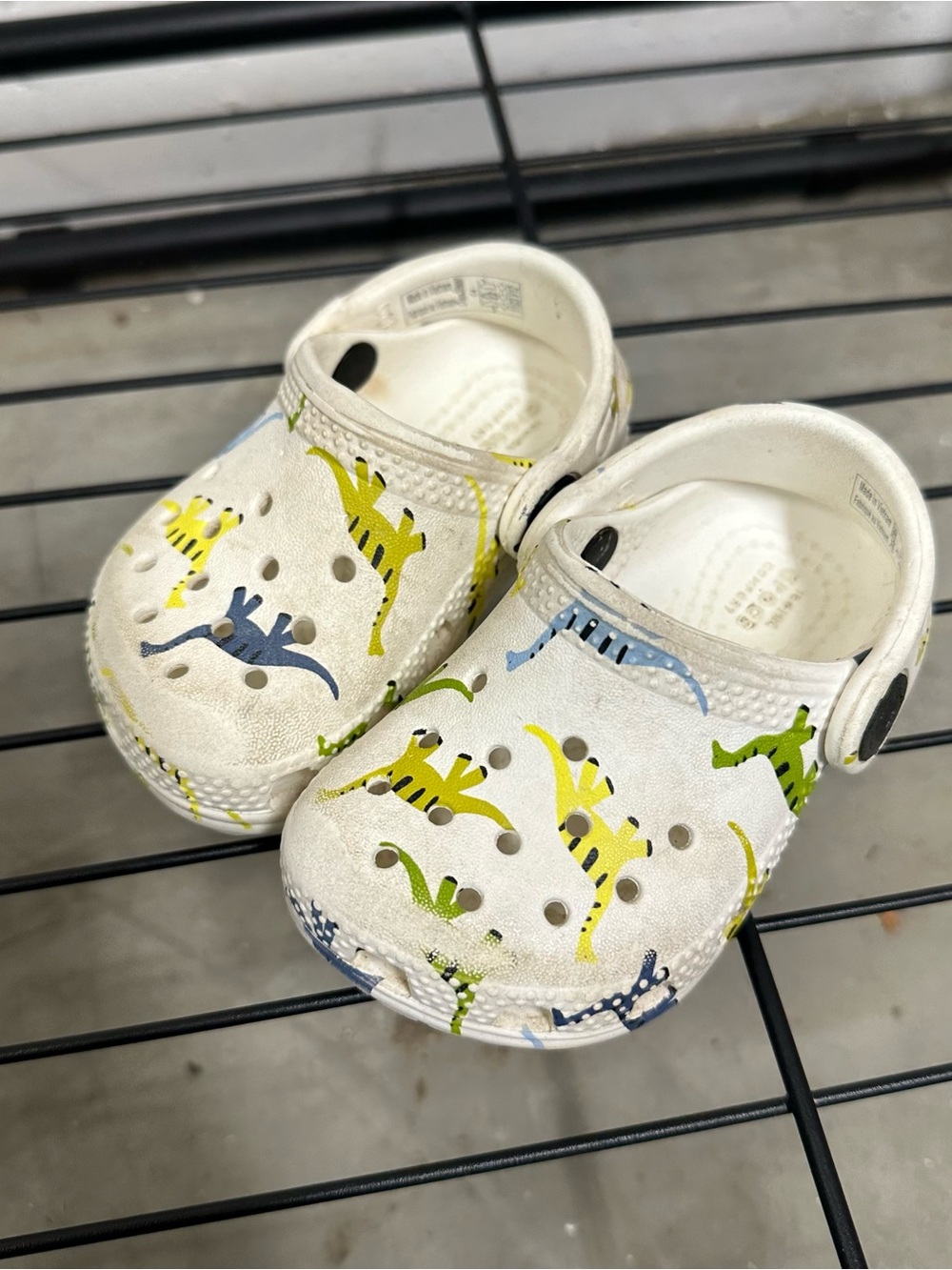 CROCS White Kids' Clogs with Green, Yellow & Blue Dinosaur Print